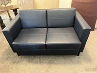 Front view of navy blue leather love seat