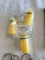 Three yellow plastic pill cases in plastic bags on fabric background