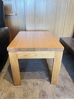 Front view of the vintage solid oak side table showing construction and leg design.