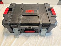 Closed black and red plastic toolbox with Summit Tools logo on top and metal latches on front.