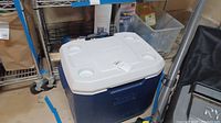 Photo of large blue and white Coleman cooler with lid and cup holders