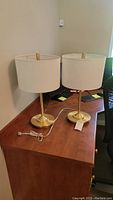 Pair of matching table lamps on a wooden desk, showing overall look and height relative to desk.