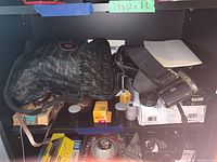 Full shelf view with camera bags, film boxes, flash and cameras