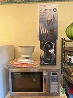 Microwave with kitchen scale, butcher block, Bobble jug in box on top