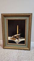 Full view of the original candle still life painting in its heavy wooden frame, showing the artwork and frame details.