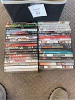 Photo of the majority of the DVD collection showing titles arranged in four columns on the floor.