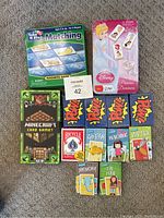 Photo shows 5 Minecraft Card Game decks, 5 Hoyle card games, Take N Play Magnetic Matching Game, and Disney Princess Dominoes.