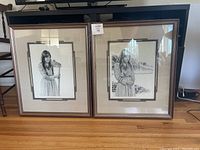 Two framed lithograph prints by James Branscum side by side on the floor, showing the full frames and mats.