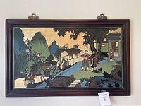 Full front view of the framed Japanese village relief wall art showing the entire scene including figures, trees, mountains, and gold leaf sky.