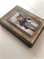 Front cover of book showing detailed illustrated image of two children in Victorian attire with gold border and title