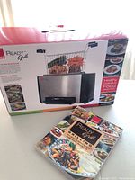 Box showing Ronco Ready Grill with product image and scale