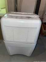 Front view of the white Whirlpool Gold dehumidifier showing air vent and overall size and shape