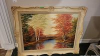 Front view of the framed landscape painting showcasing the full artwork and ornate frame.