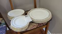 Stack of dinner and side plates showing blue and gold floral border