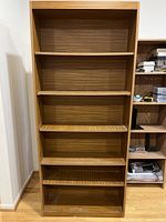 Full view front of the wooden bookshelf showing empty shelves and back panel.