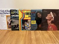 First photo of the front covers of 6 LP albums showing titles such as 'Cock A Doodle And Mother Goose', 'Children's Album', 'Funtastic 50', 'Joyce', and 'Olivia' by Olivia Newton-John.