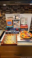 Overview of lot with Mad Gab, glass chess/backgammon, Pochbrett, cards, and Tupper Toys