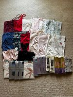 Full lot showing lingerie slips in multiple colors and packaged pantyhose on floor.