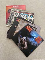 Top view of all 7 vinyl records showing album covers including Ozzy Osbourne, Meat Loaf, Led Zeppelin, Jimi Hendrix, Cheap Trick, Rolling Stones