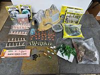 Overview photo showing all items including tunnel, figures, trees, retaining walls, and other accessories arranged on tile surface