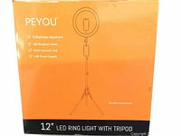 Photo of the orange and black retail box showing the 12 inch LED ring light with tripod and features like 10 brightness adjustments, 360-degree rotation, USB power supply