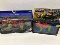 Two boxed Battle Cat figures from Masters of the Universe, one modern Masterverse Revolution and one vintage style packaging.