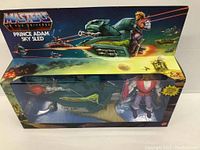 Photo showing full box packaging with Masters of the Universe branding and artwork featuring Prince Adam Sky Sled and figure inside