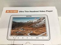 Photo of the product box showing the W-1018D Ultra Thin Headrest Video Player with a large screen and control buttons below it.