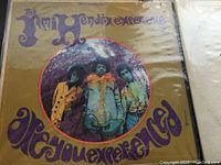 The Jimi Hendrix Experience 'Are You Experienced' vinyl record album cover showing band members in colorful attire with psychedelic font.