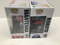Side view of Man-At-Arms and Roboto Funko Pop boxes, showing character names and box numbers