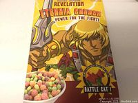 Front side of the Eternia Crunch cereal box showing He-Man with a sword, colorful cereal in a bowl, and reference to the sealed Battle Cat toy included.
