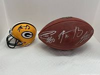 Mini helmet and football side by side on white background