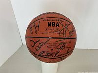 Front angle overview of Spalding NBA official basketball with multiple signatures