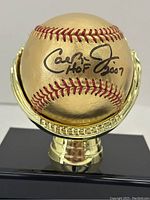 Close-up of signed sweet spot on gold-painted baseball
