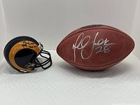 Wide shot showing both football and mini helmet side by side