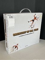 White cardboard slipcase with printed 'Greatest of All Time: A Tribute to Muhammad Ali' title and handle, three-quarter view