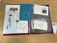 Maroon folder with Samuel French script, signatures and clippings inside sheet protectors