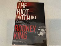 Front cover of The Riot Within showing title, author, and dust jacket artwork