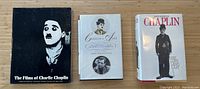 Three Charlie Chaplin books displayed side by side on a wood surface