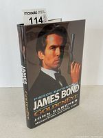 Three-quarter view of hardcover book with dust jacket showing Pierce Brosnan cover art and title.