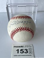 Baseball in display case showing full signature on sweet spot