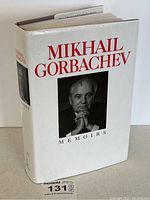 Front and spine of hardcover with dust jacket showing title and portrait.