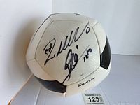 Front angled view showing signatures and MaxSold tag