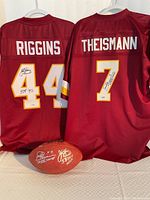 Two Washington Redskins jerseys and autographed football displayed together
