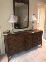 Full view of dresser with attached wall mirror in room setting