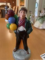 Front view of the Royal Doulton Balloon Boy figurine showing the boy holding multi-colored balloons.
