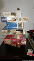 Stack of seven puzzle boxes with titles and brands visible including Master Mountain and Eurographics.