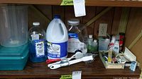 Overview photo showing entire shelf with all cleaning supplies and miscellaneous items as described.