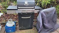 Full front view of the Cuisinart propane BBQ grill with cover and propane tank visible
