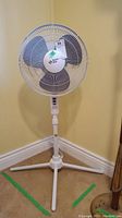 Overall view of the Confort Zone 42-inch floor fan showing front and side angle, tripod base, and control panel on fan stand.